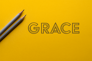Grace - yellow background with 2 pencils